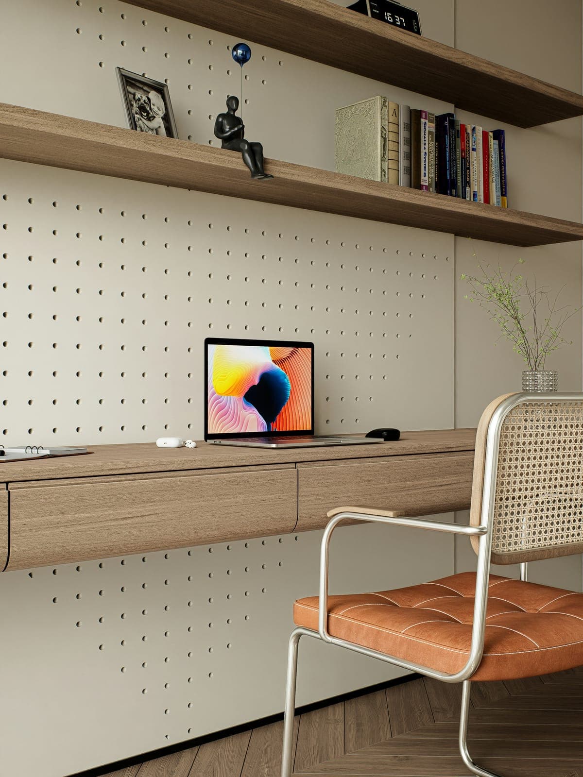 A desk with a laptop in a bright studio