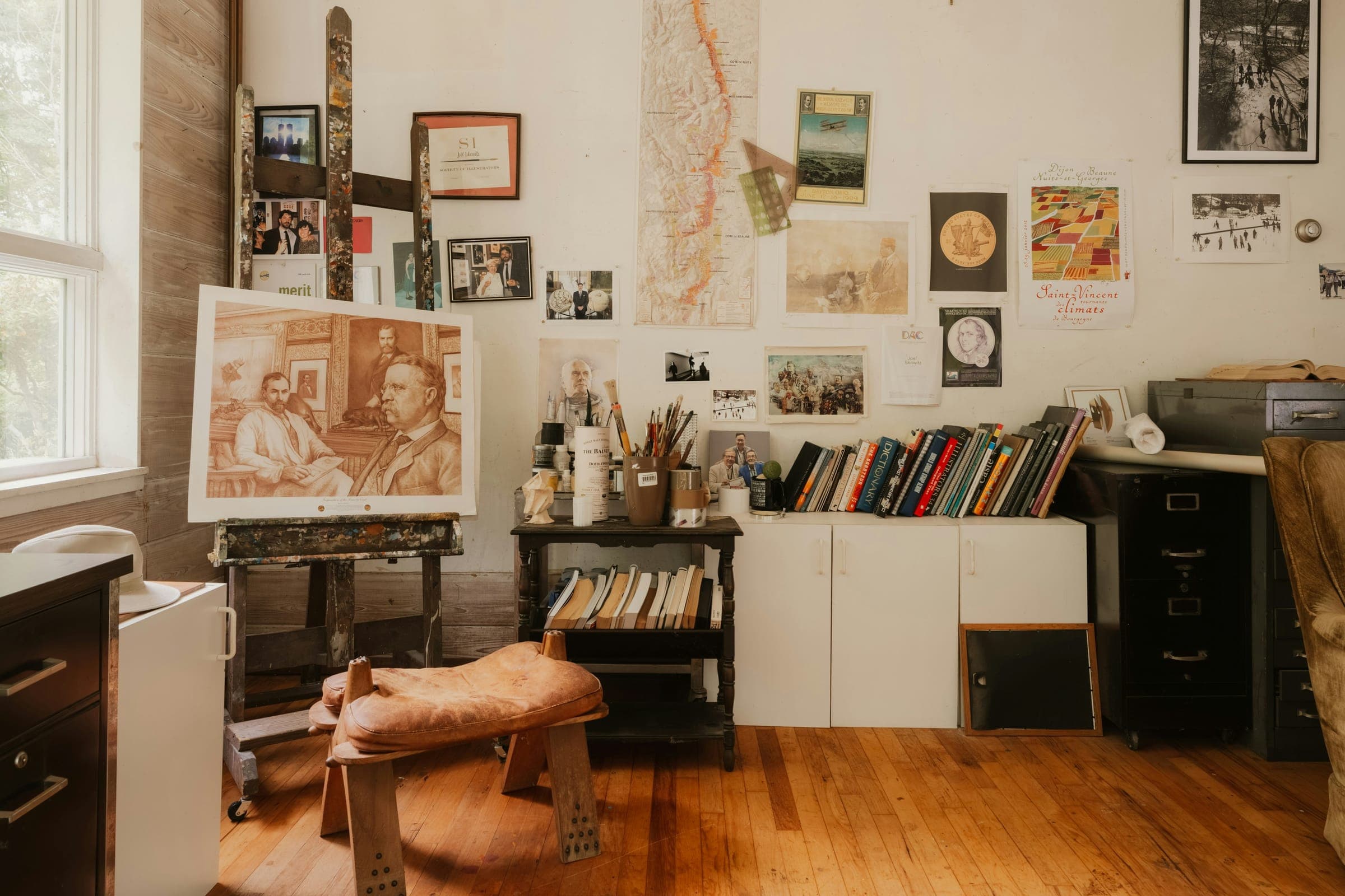 An artist's studio with paintings on the walls